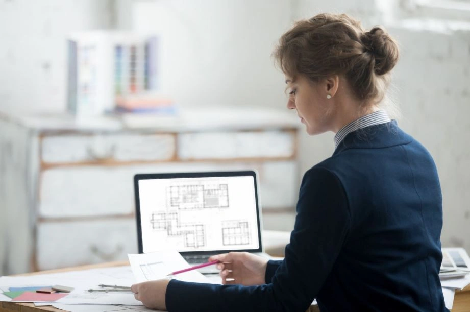 architect reviewing architecture portfolio projects on laptop