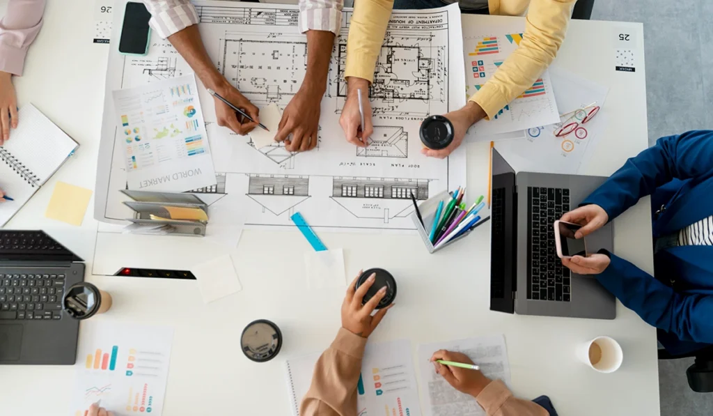 architecture studio team reviewing architectural drawings and design plans